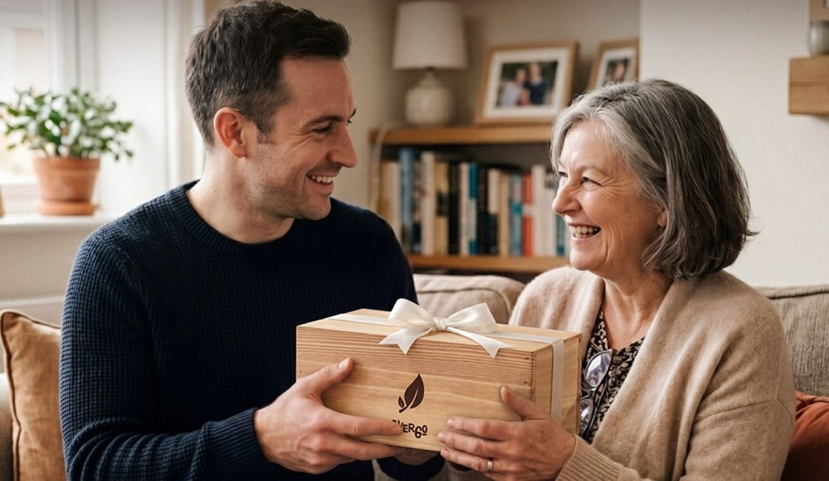 A son hands his mother a wooden Avergo gift box tied with a ribbon